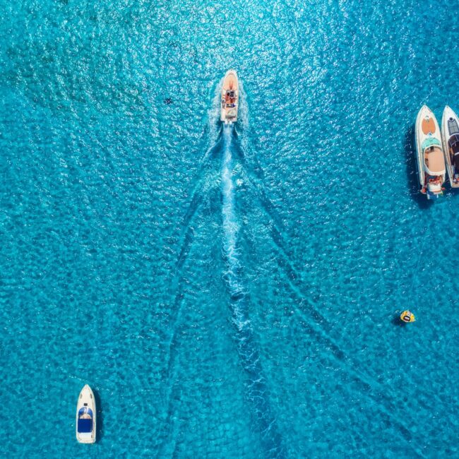 Aerial view of luxury yachts in transparent blue sea